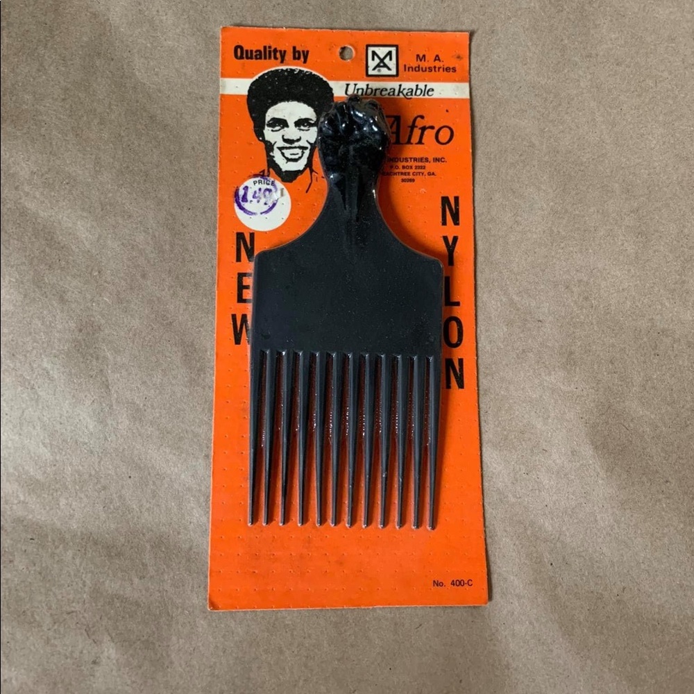 VINTAGE AFRO PICK with clenched raised fist.